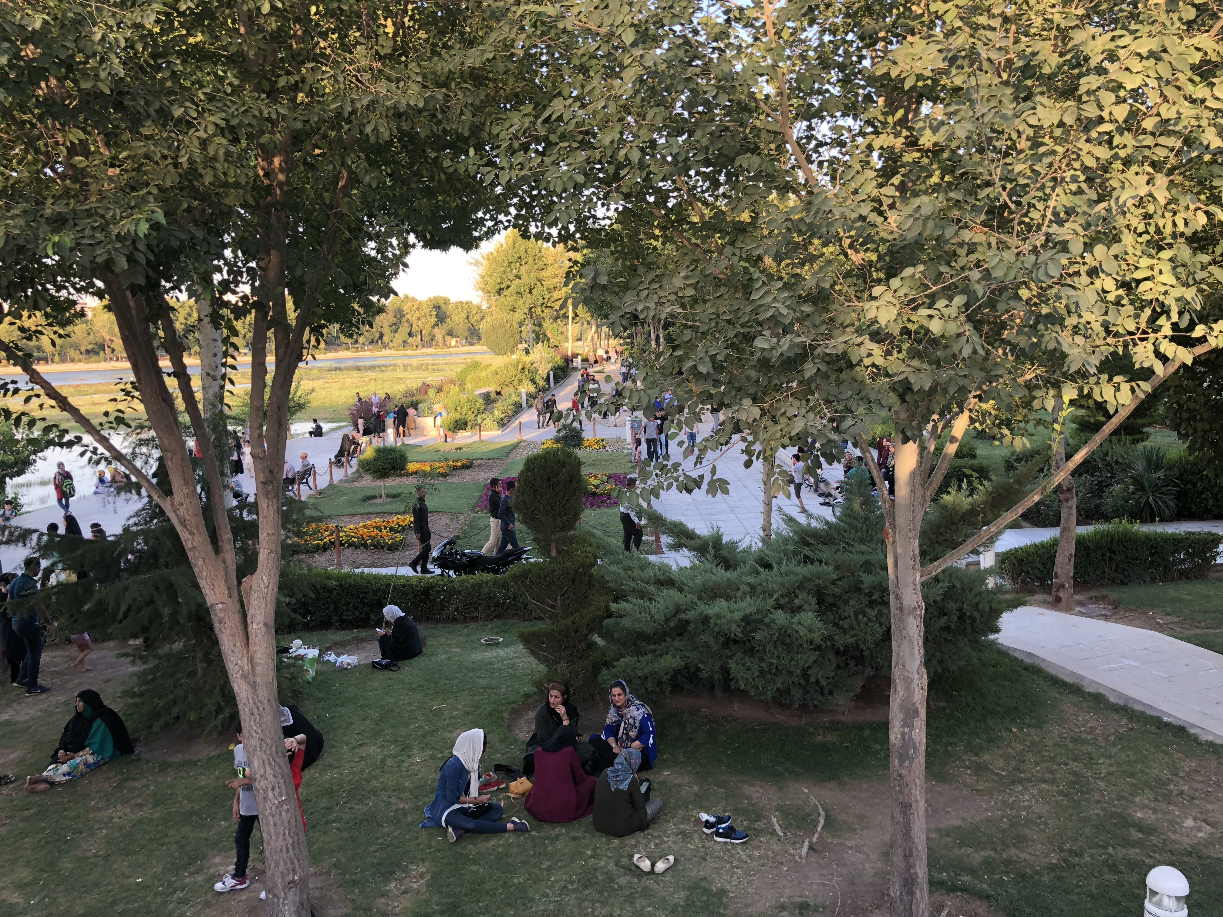 Iran — park scene with locals relaxing under trees, Esfahan
