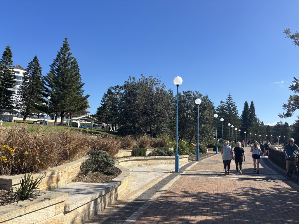 Coogee Beach promenade in 2026 looking north.  33 years after redesign of the reserve and closure of Beach Street
